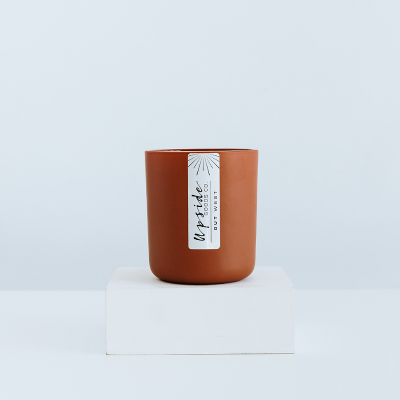 Terracotta Clay Signature color glass in a 12oz matte vessel featuring Out West new Fall 2025 scent 