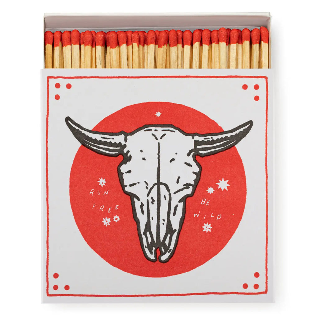 Matches with a bull skull design and motivational text on a red background